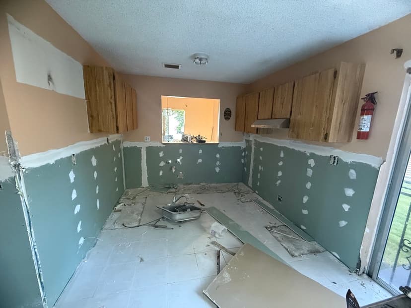 Damaged drywall cut out and replaced with moisture-resistant board.