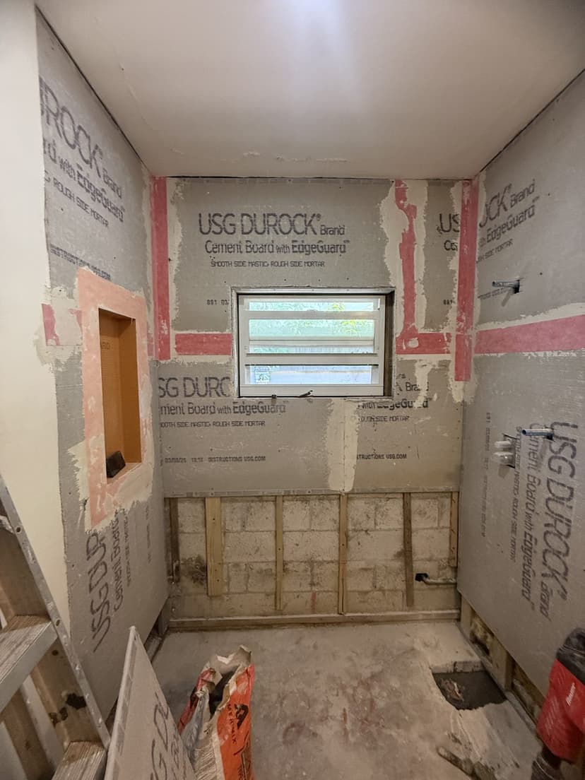 Gutted to the studs, cement board up and seams waterproofed.