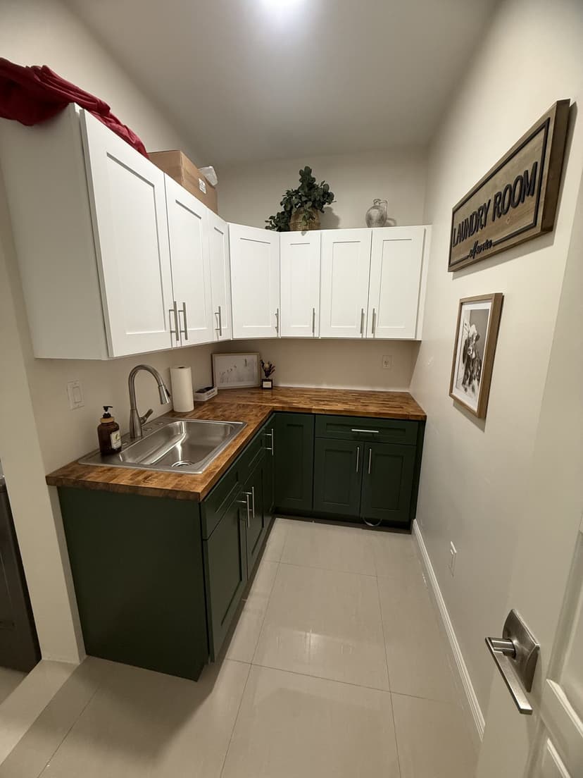 White uppers, green base cabinets, butcher block top and a new sink.