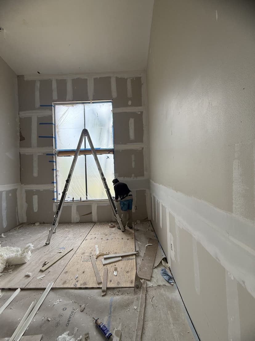 New drywall hung and taped up the full height of the wall.