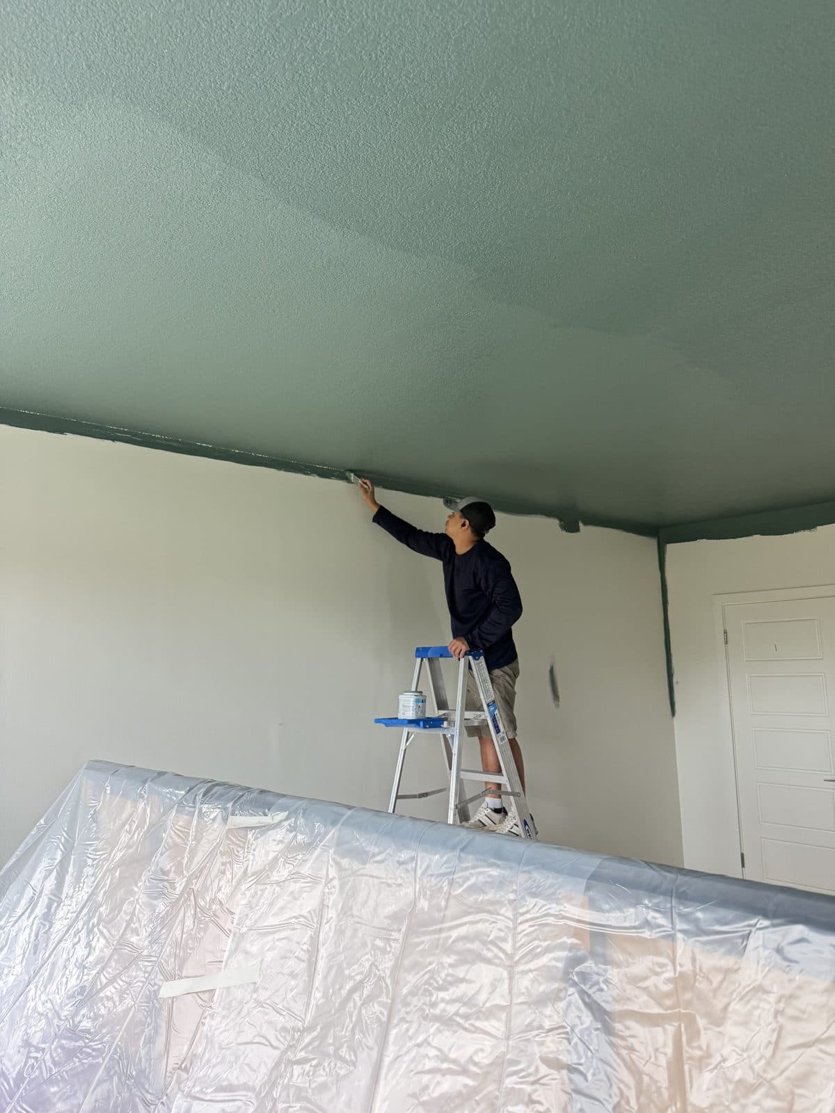 Furniture wrapped and floors covered before interior painting in Miami