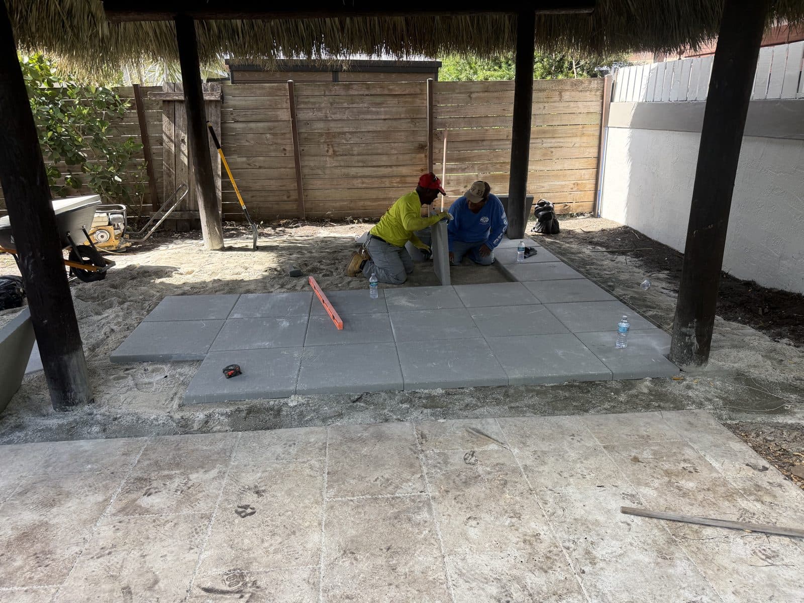 Leveling the base and setting pavers on an exterior repair job in Miami